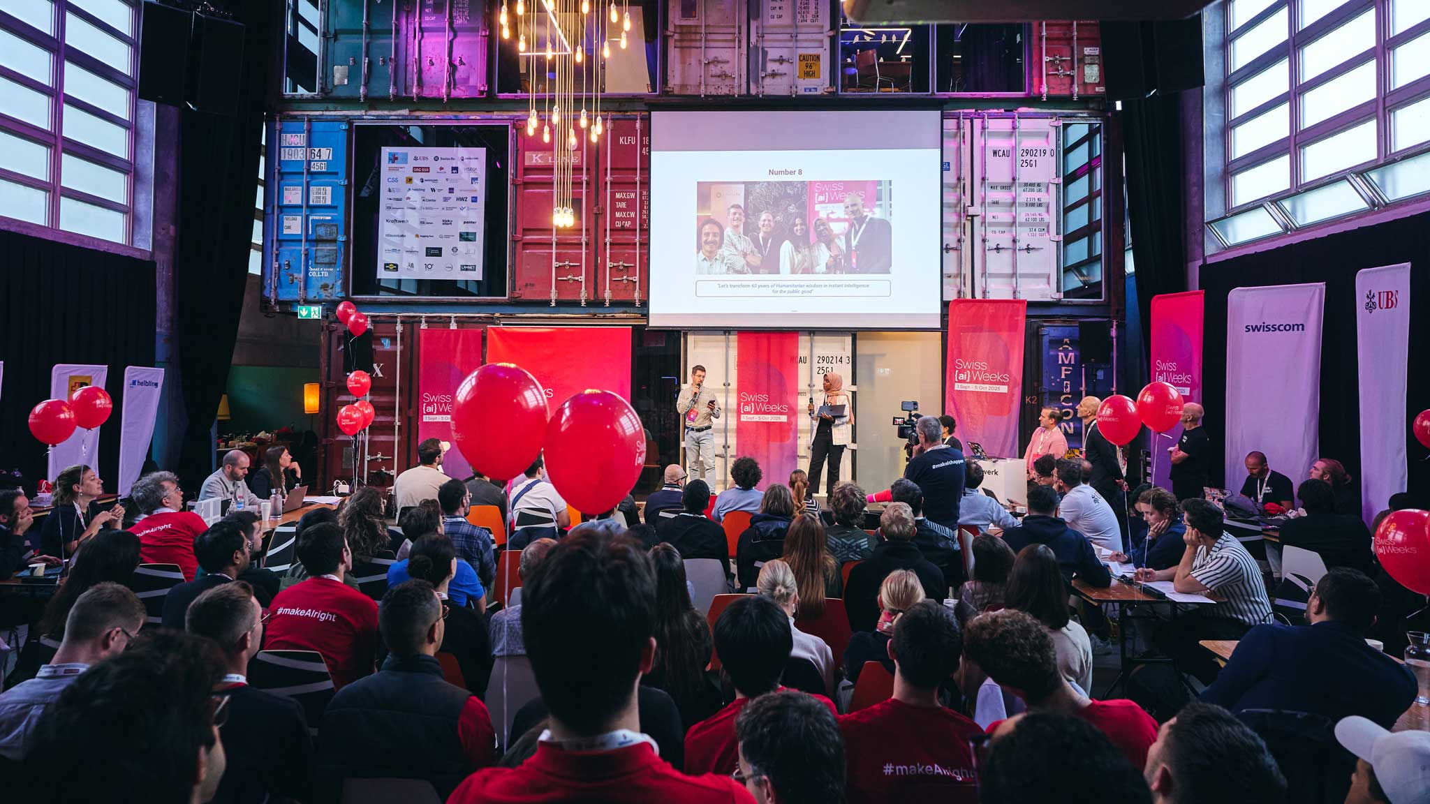 Hackers collaborating at a Swiss {ai} Weeks event