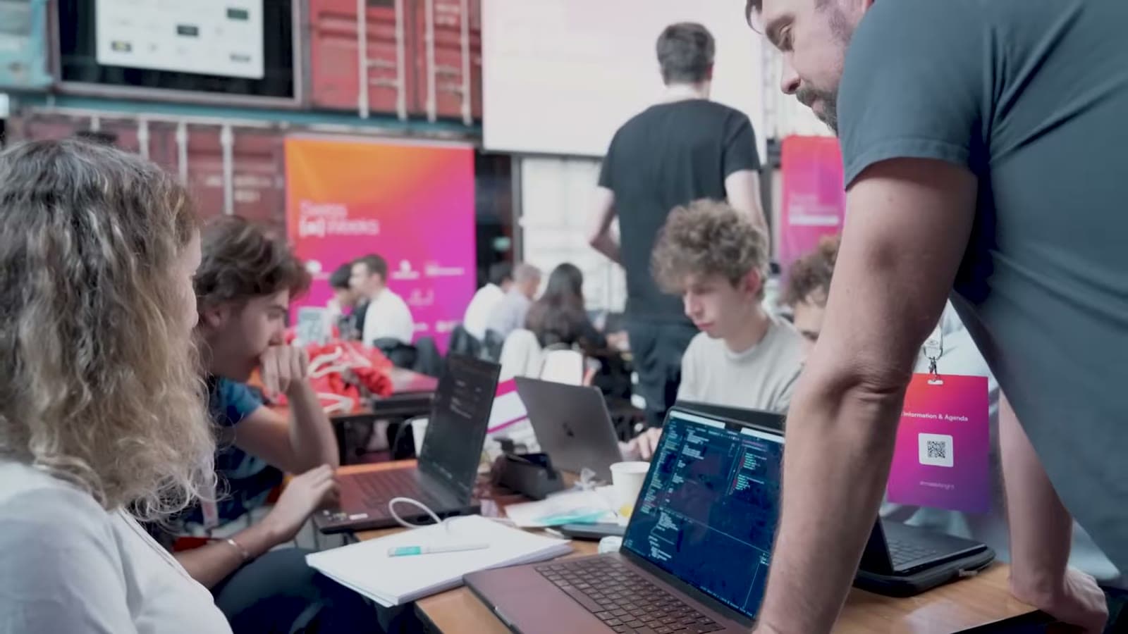 Teams working side by side between Swiss {ai} Weeks banners