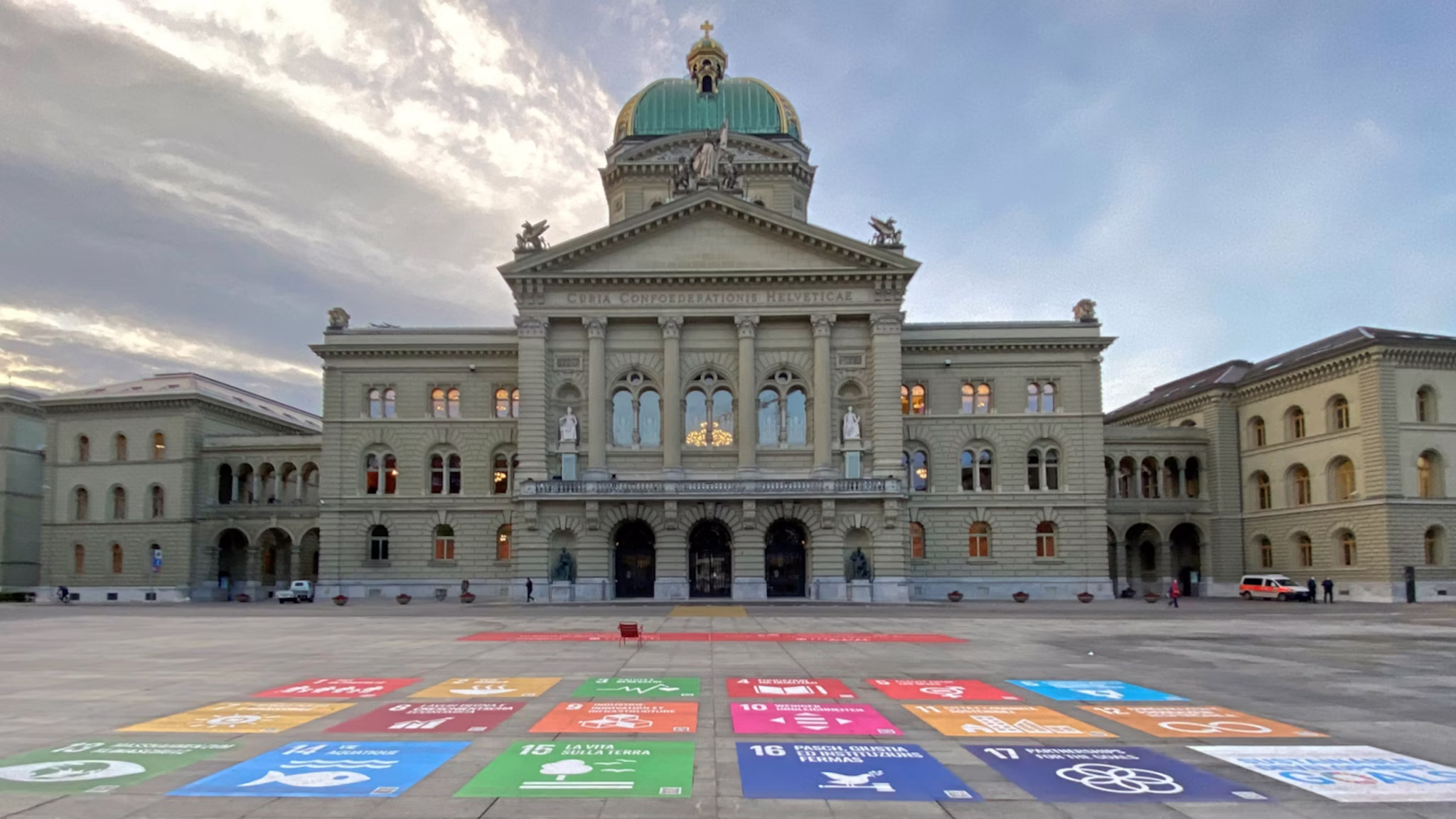 Swiss Federal Palace illuminated with the Sustainable Development Goals colour wheel